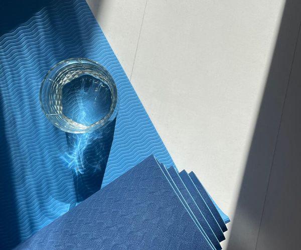 A calm and clean studio interior with natural light and yoga mats.